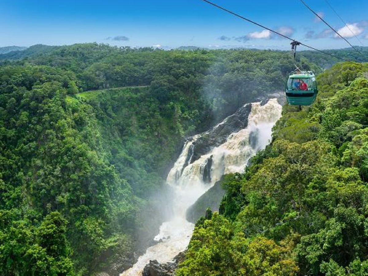 a train on a track with smoke coming out of the water