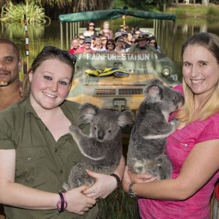 a person holding a dog posing for the camera