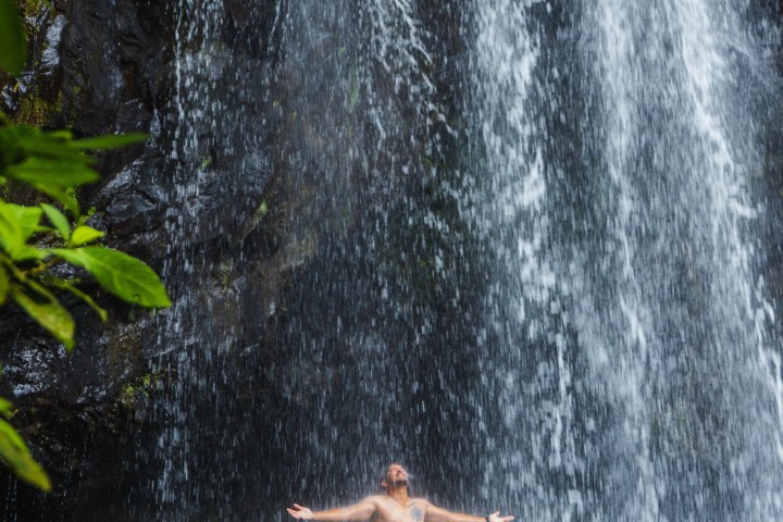 a large waterfall over a body of water