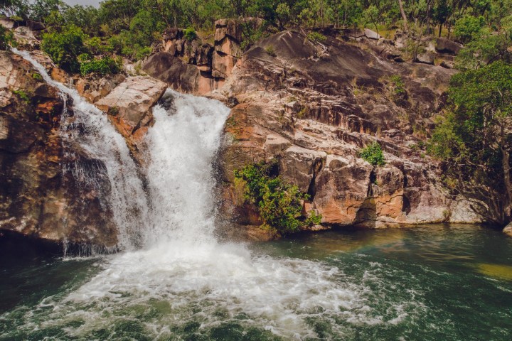a large waterfall over some water