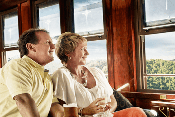 a man and woman sitting next to a window