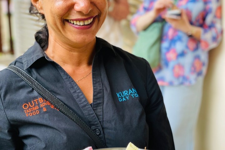 a woman sitting at a table with a plate of food